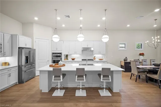 a large kitchen with a table and chairs
