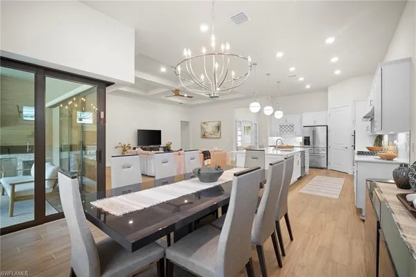 a large kitchen with a table and chairs