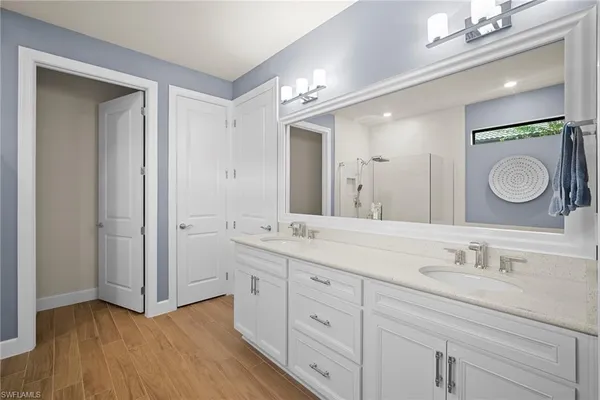 a bathroom with a double vanity sink and a mirror