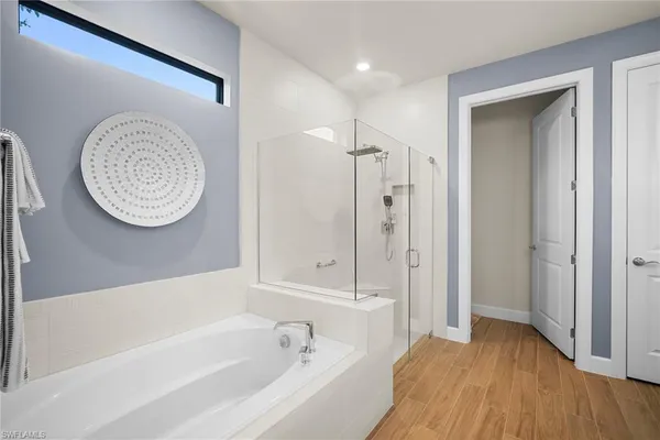 a bathroom with a bathtub a toilet and a shower