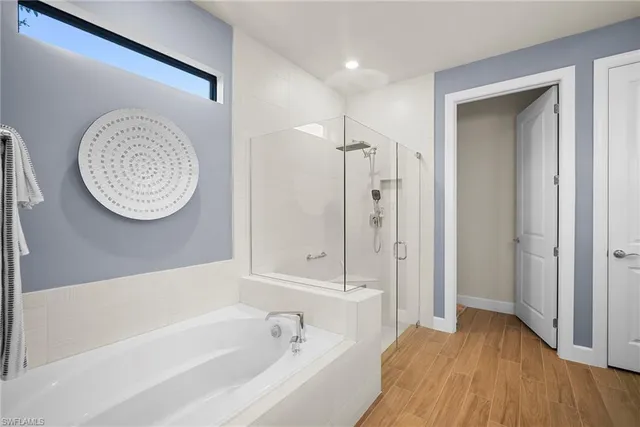 a bathroom with a bathtub a toilet and a shower