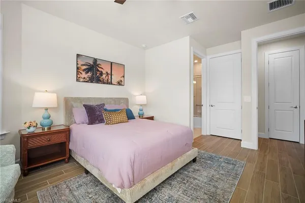 a bedroom with a bed and a night stand