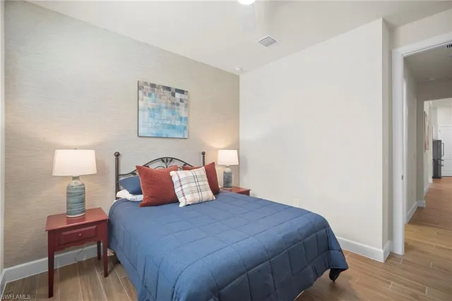 a bedroom with a bed and a lamp on table