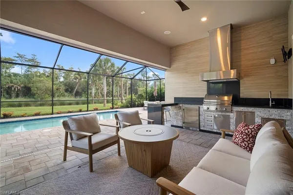 a living room with furniture and a floor to ceiling window