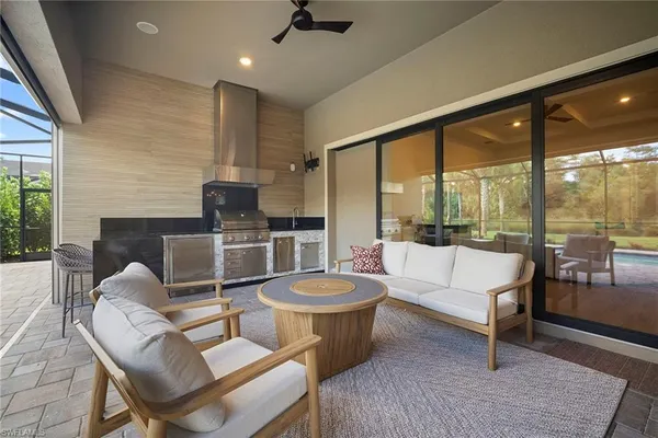 a living room with fireplace furniture and a large window