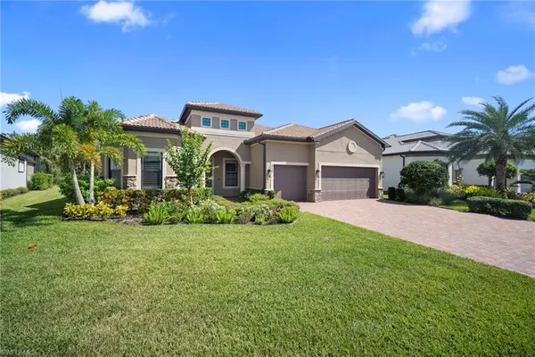 a view of a house with a big yard and potted plants