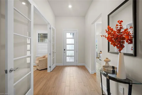 a view of a hallway with wooden floor and entryway