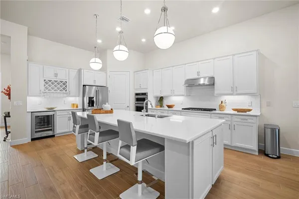 a kitchen with a sink cabinets and wooden floor
