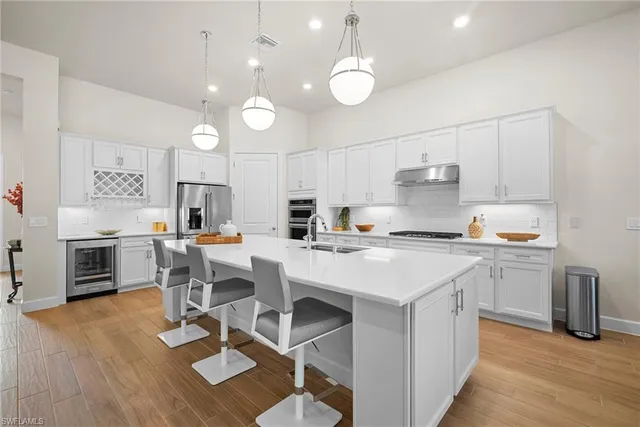 a kitchen with a sink cabinets and wooden floor