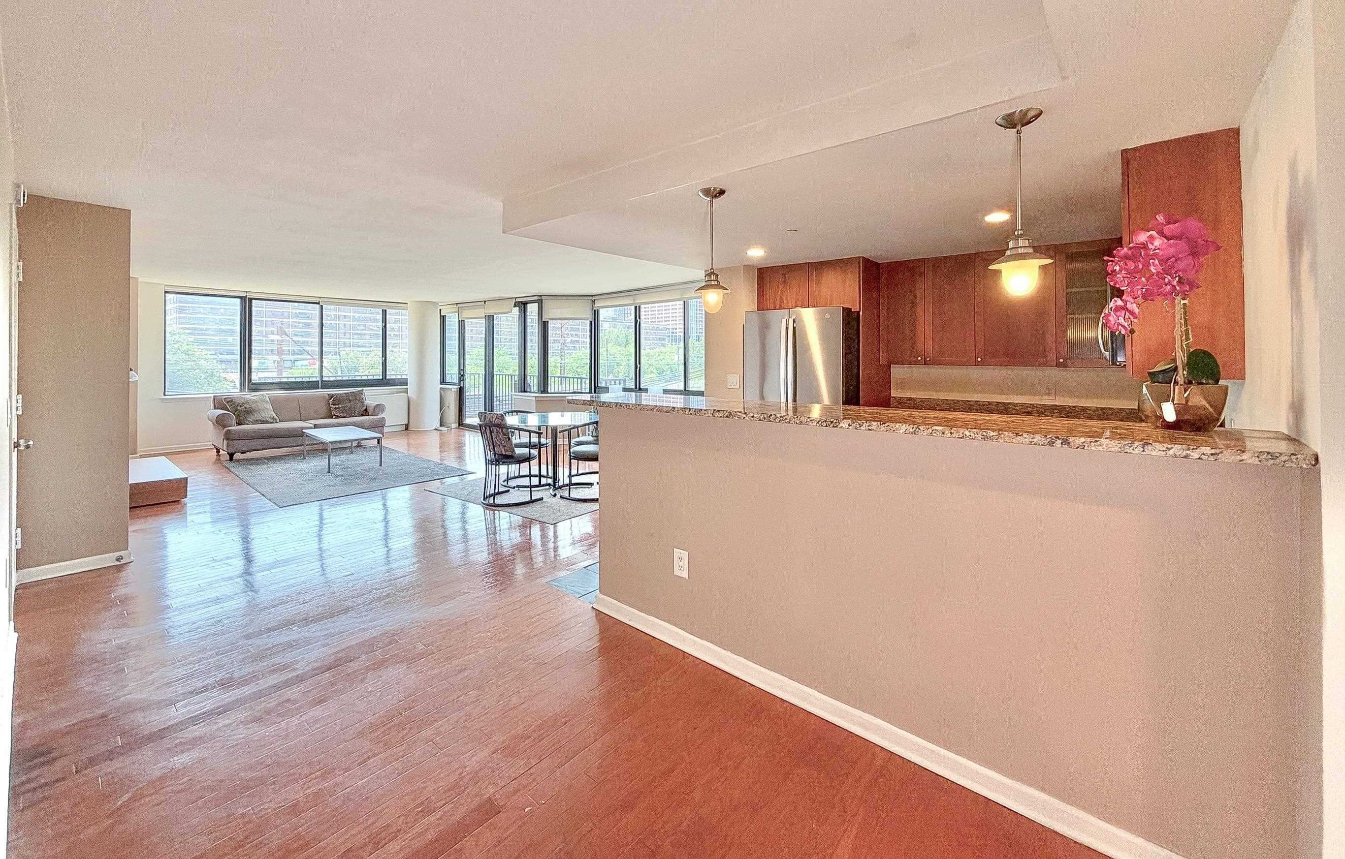 700 Grove Street, Unit 4F Jersey City, NJ 07310 - Photo 11 of 30 a living room with furniture and a wooden floor