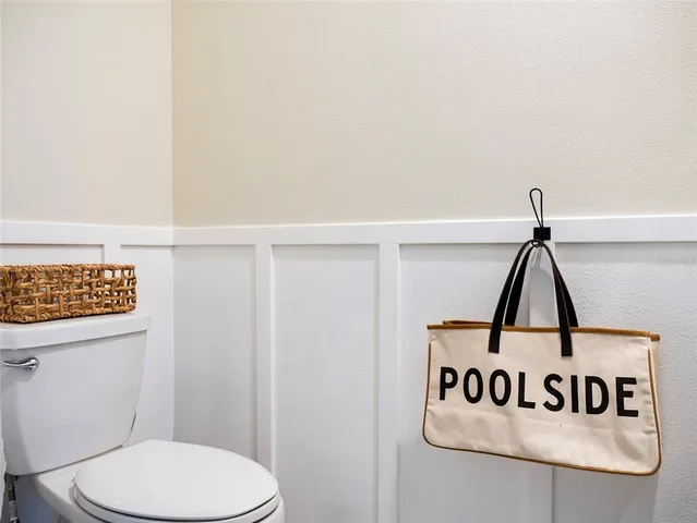 a bathroom with a toilet and a view of bathroom