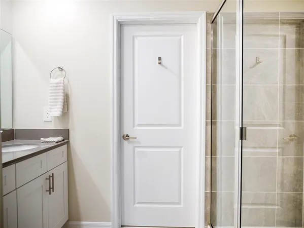 a bathroom with a shower and a sink