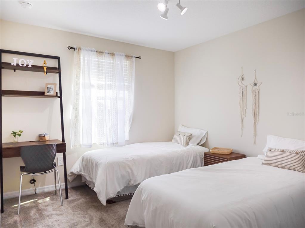 2949 Muller Oak Loop Ocoee, FL 34761 - Photo 28 of 36 a bedroom with two beds and a chair