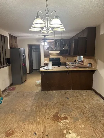 a view of kitchen with refrigerator stove and microwave