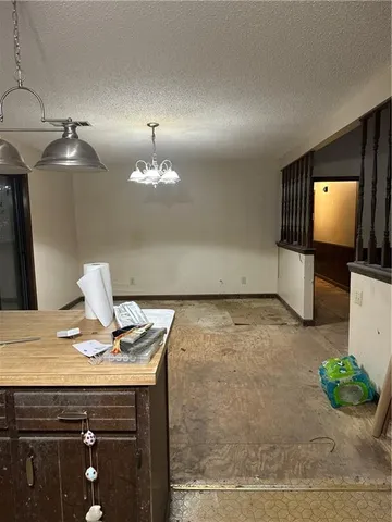 a view of kitchen with kitchen island stainless steel appliances and living room view