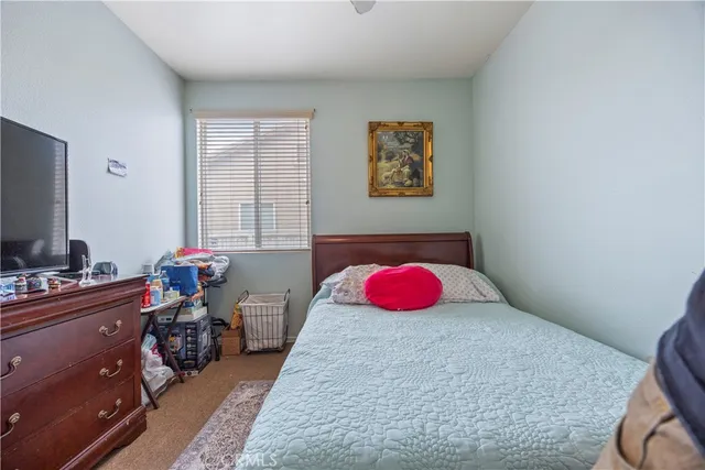 a bedroom with a bed and a chair