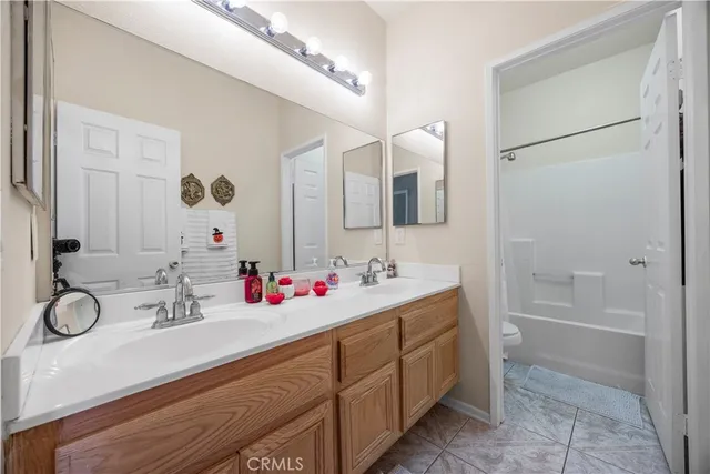 a bathroom with a sink vanity tub and toilet