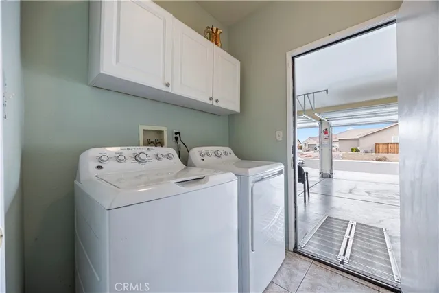 a view of a patio with table and chairs potted plants with wooden floor and fence