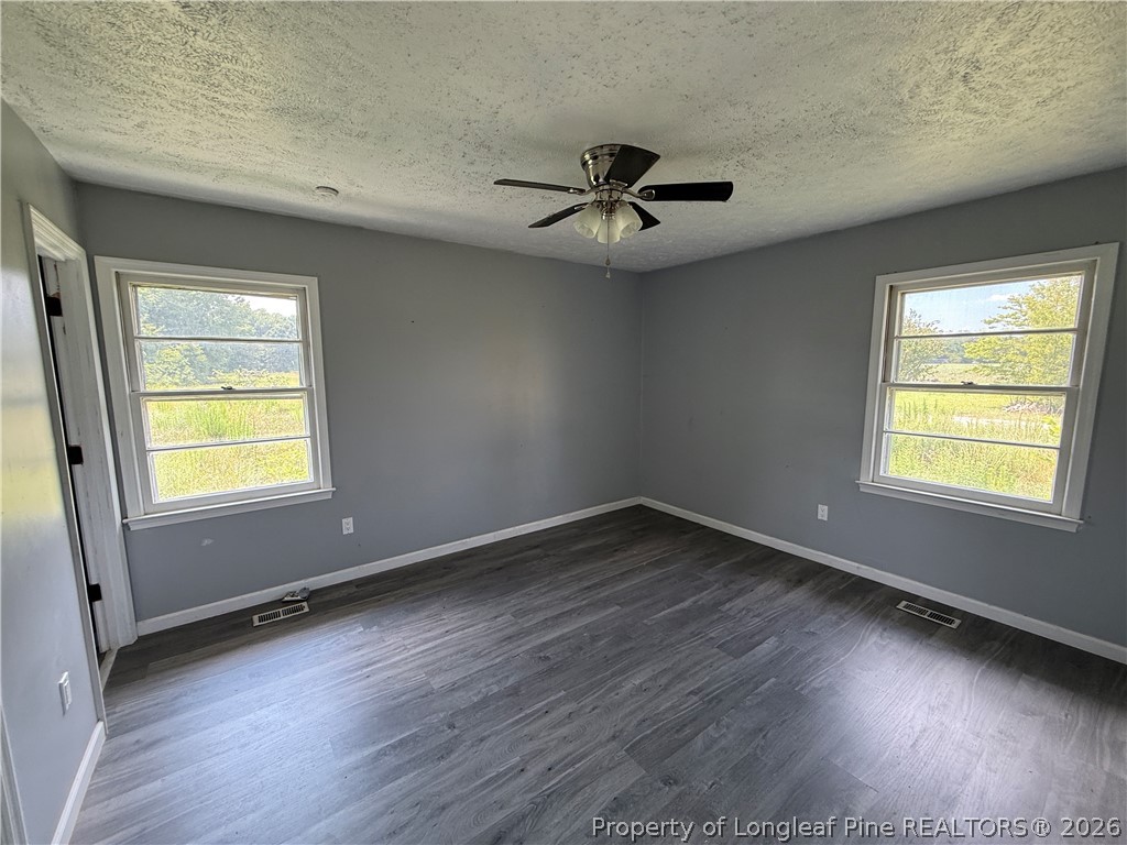 736 Tobermory Road Fayetteville, NC 28306 - Photo 7 of 17 a view of empty room with wooden floor and fan