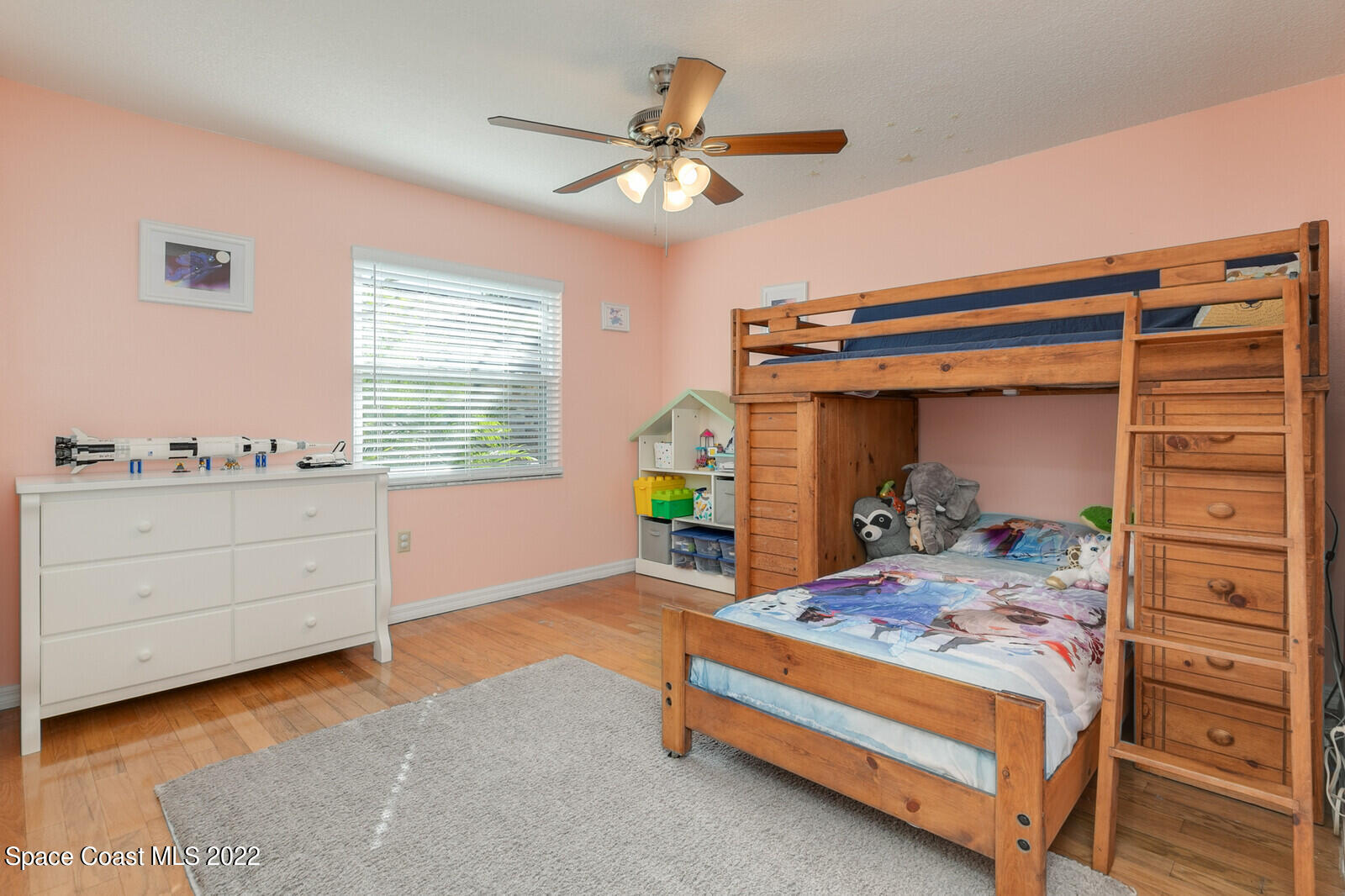 6385 Banks Avenue Cocoa, FL 32927 - Photo 14 of 47 a bedroom with a bed and a chandelier
