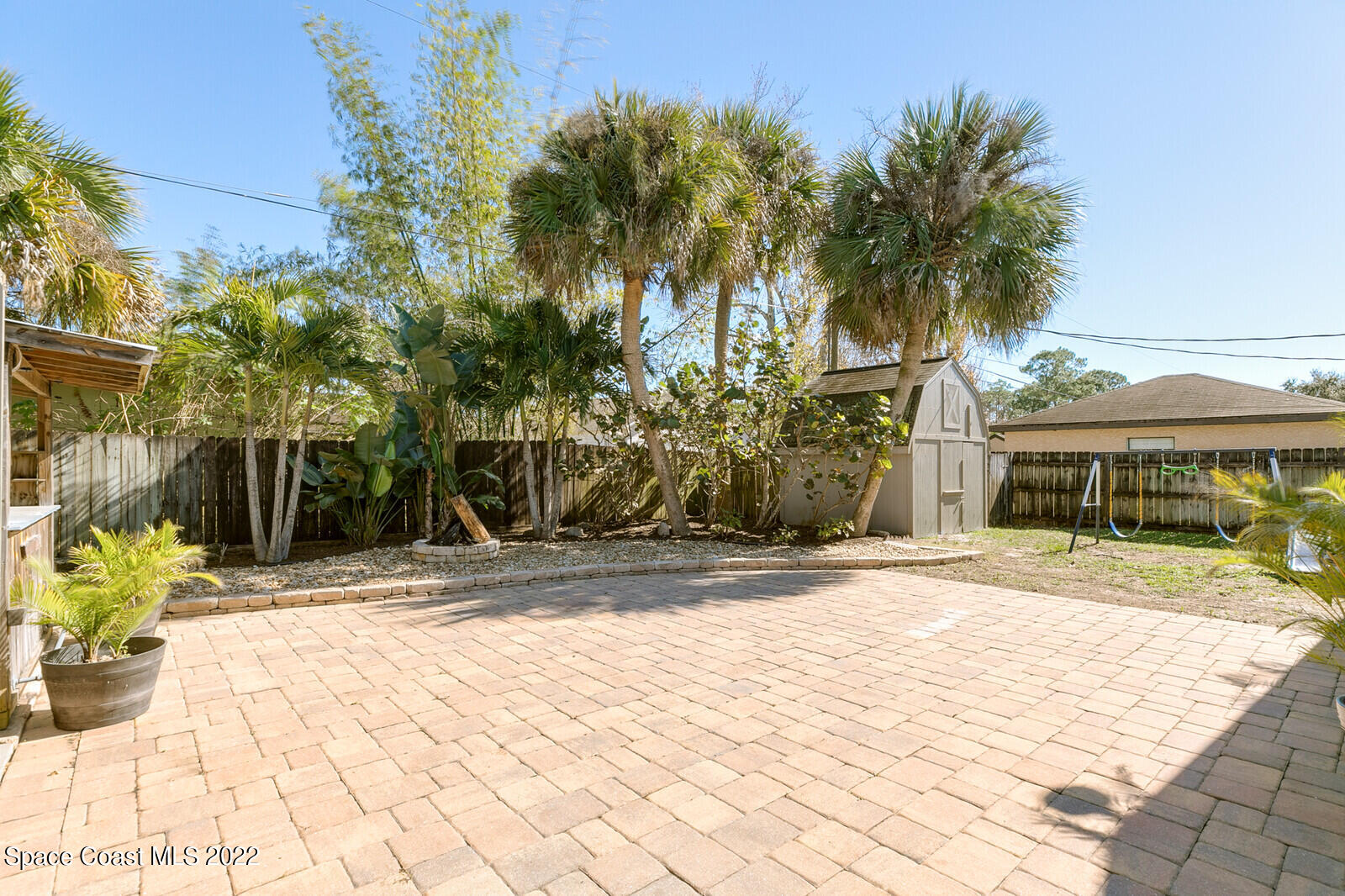 6385 Banks Avenue Cocoa, FL 32927 - Photo 22 of 47 a view of a house with a yard and coconut trees