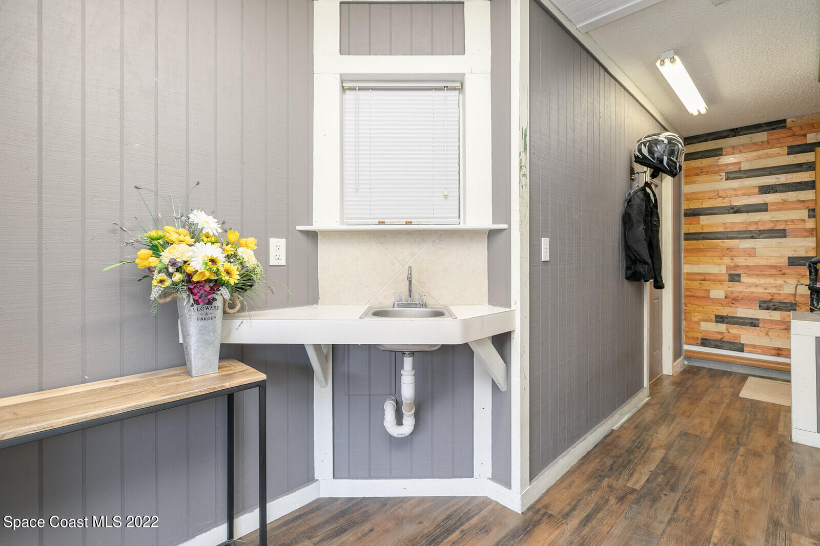 6385 Banks Avenue Cocoa, FL 32927 - Photo 7 of 47 a bathroom with a sink a mirror and a potted plant