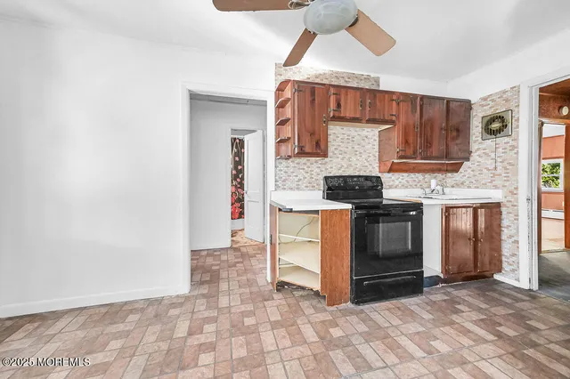 a view of kitchen with granite countertop cabinets and stainless steel appliances