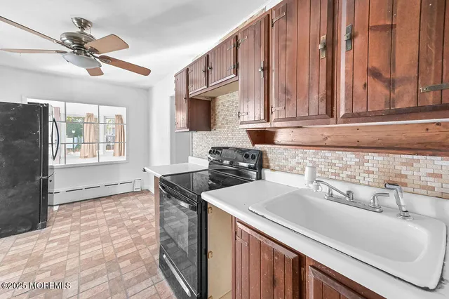 a kitchen with a sink cabinets and appliances