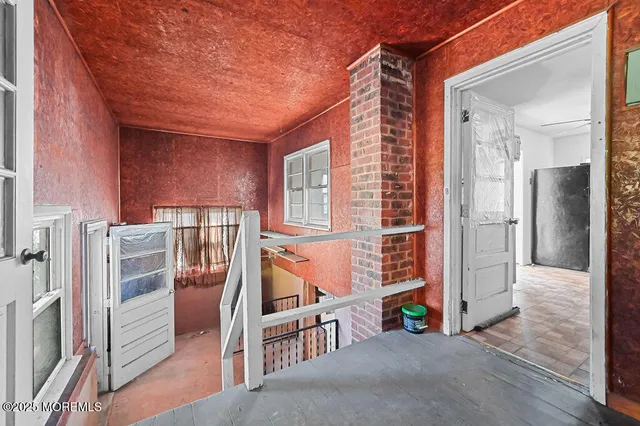 a view of a porch with a table and chairs