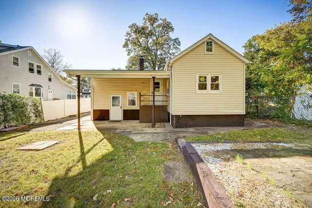 a view of a house with pool and sitting area