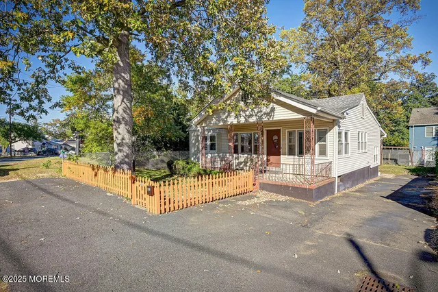 a view of house with swimming pool and sitting area