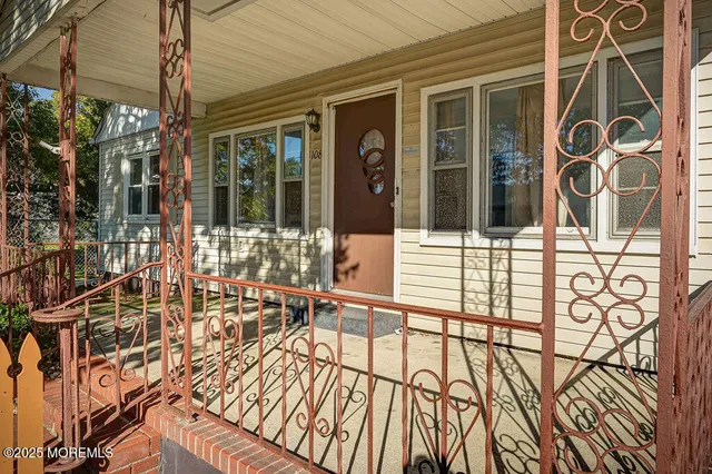 a view of a house with a large window and wooden floor