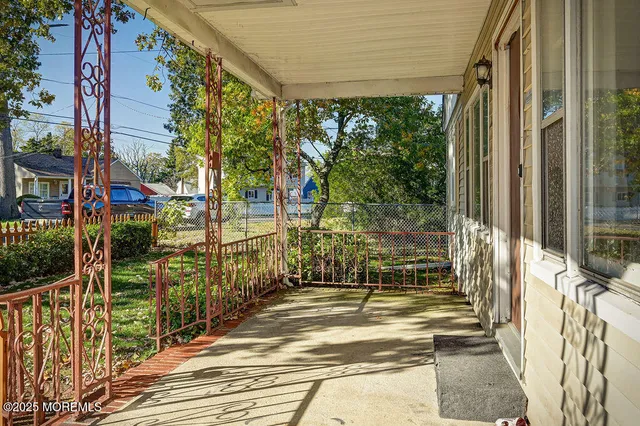 a view of a room with wooden floor and door