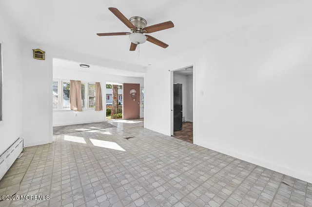 a view of a big room with closet and windows