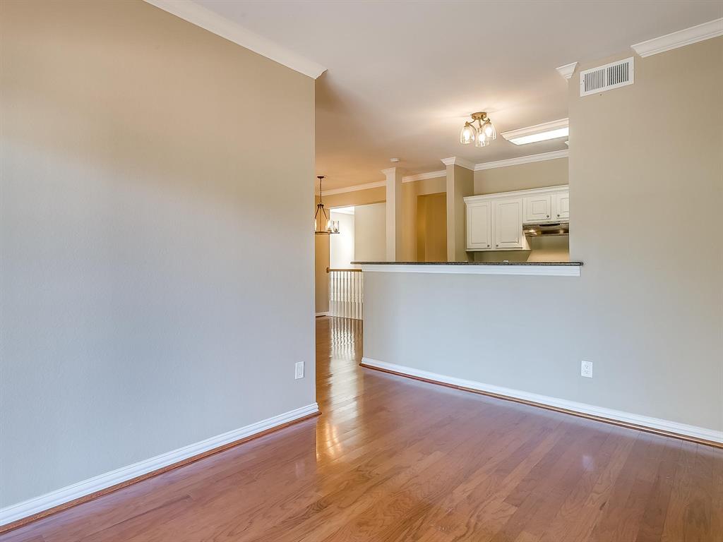 2524 Preston Road, Unit 1303 Plano, TX 75093 - Photo 13 of 28 an empty room with wooden floor and mirror