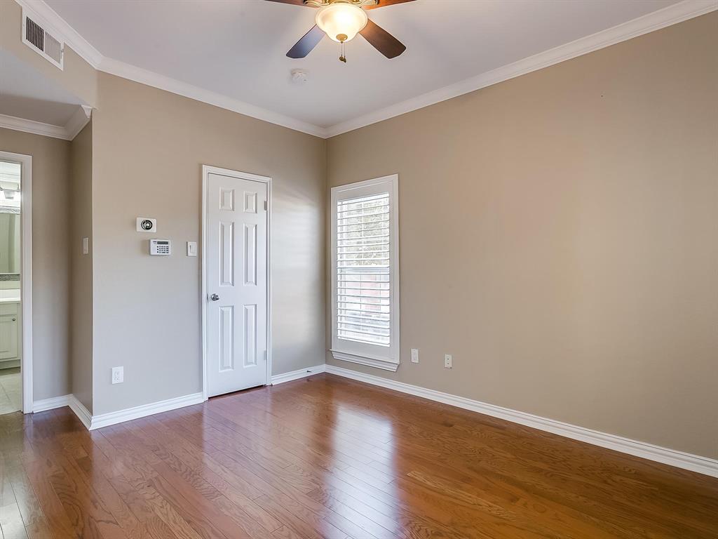2524 Preston Road, Unit 1303 Plano, TX 75093 - Photo 18 of 28 an empty room with wooden floor chandelier fan and windows