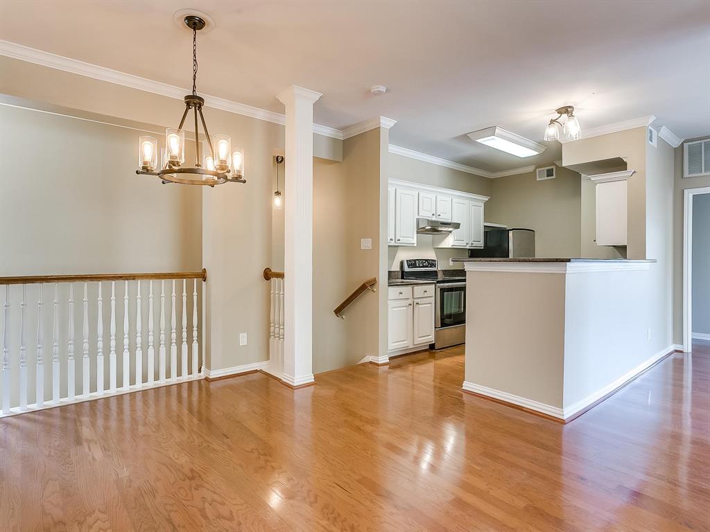 2524 Preston Road, Unit 1303 Plano, TX 75093 - Photo 5 of 28 a view of a kitchen with a sink wooden floor and a chandelier