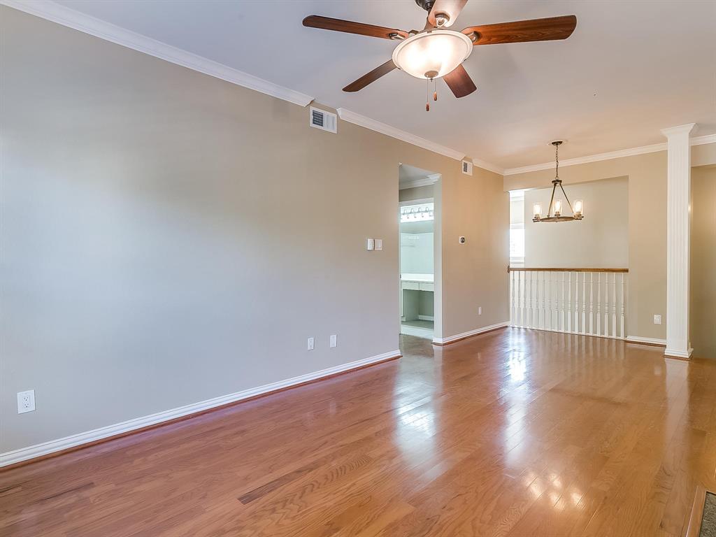 2524 Preston Road, Unit 1303 Plano, TX 75093 - Photo 7 of 28 an empty room with wooden floor ceiling fan and windows