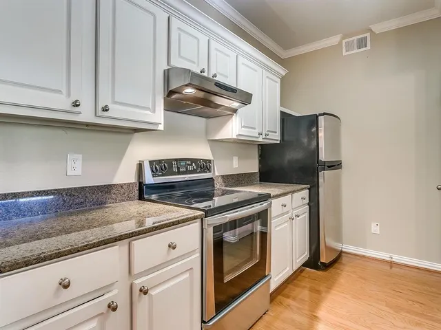a kitchen with a sink and a stove