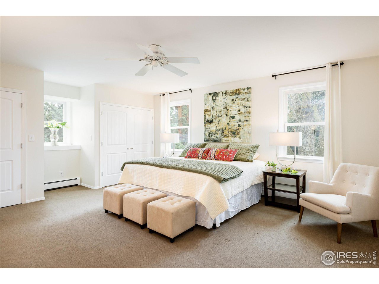 6919 Frying Pan Road Boulder, CO 80301 - Photo 17 of 36 a spacious bedroom with a bed and a couch