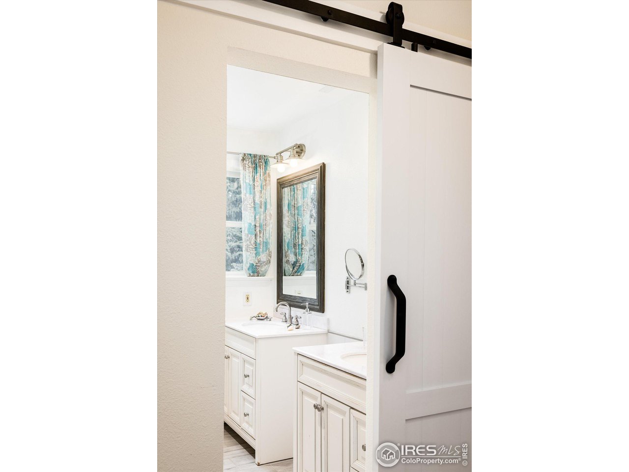 6919 Frying Pan Road Boulder, CO 80301 - Photo 21 of 36 a view of bathroom with a sink and mirror