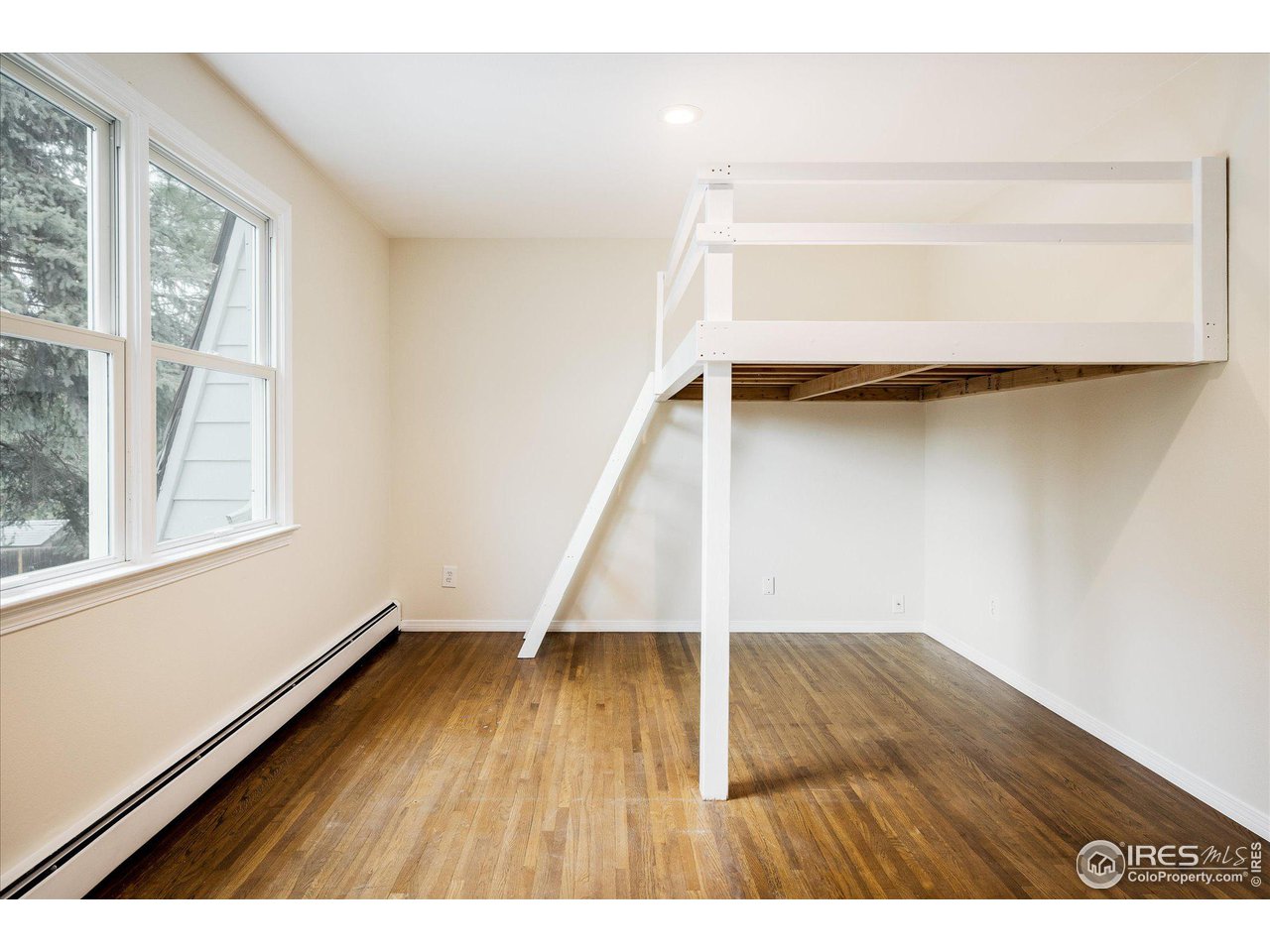 6919 Frying Pan Road Boulder, CO 80301 - Photo 22 of 36 a view of an empty room with wooden floor and a window