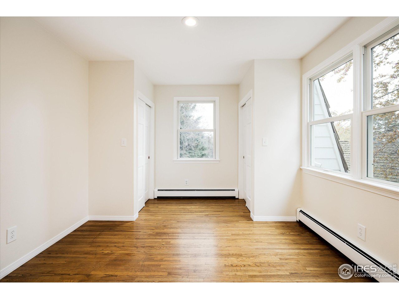 6919 Frying Pan Road Boulder, CO 80301 - Photo 24 of 36 a view of an empty room with wooden floor and a window