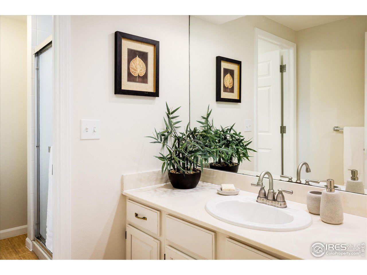 6919 Frying Pan Road Boulder, CO 80301 - Photo 27 of 36 a bathroom with a sink a mirror and painting on the wall