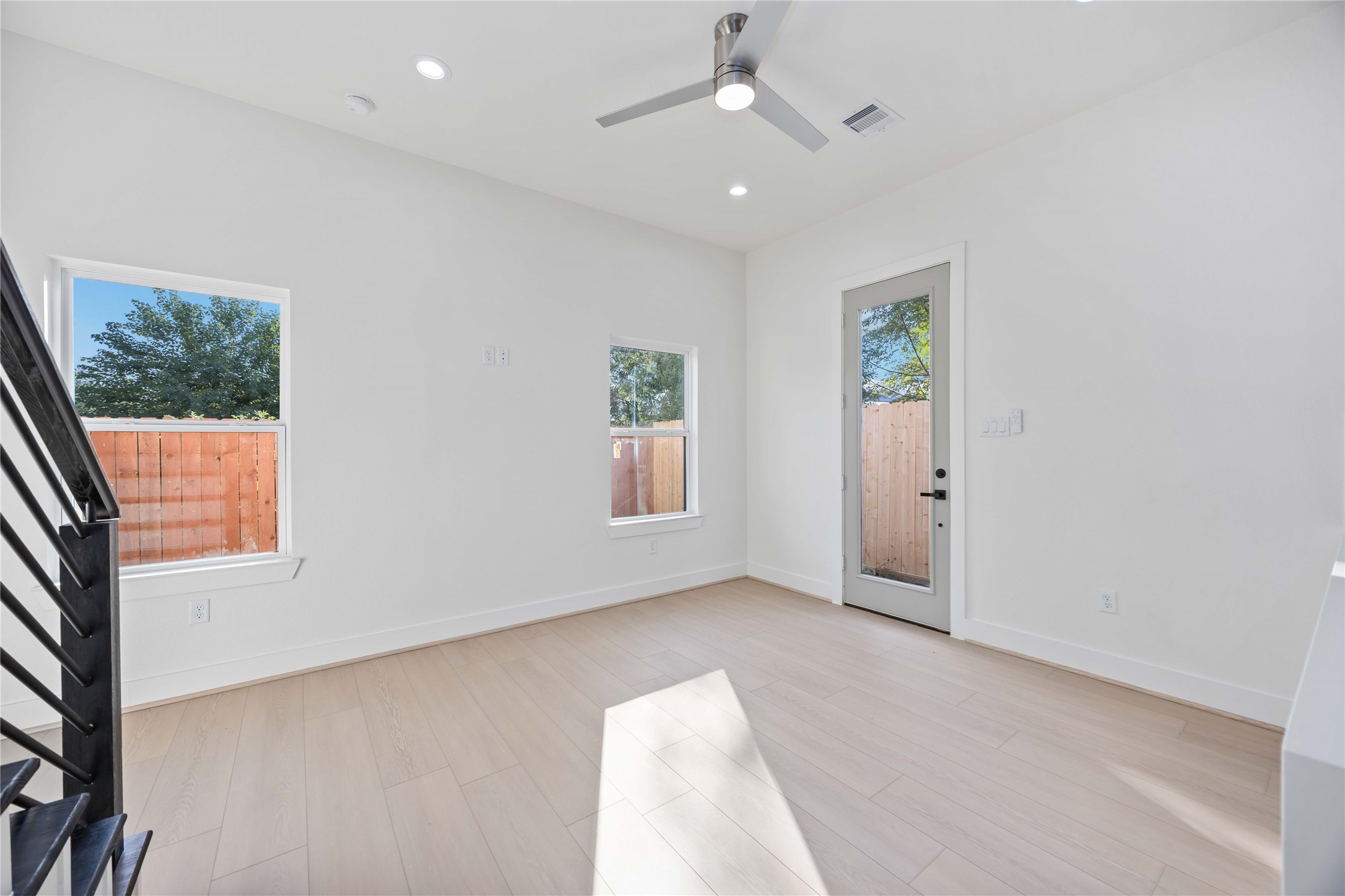 5222 Gold Street Houston, TX 77026 - Photo 11 of 28 wooden floor in an empty room with a window