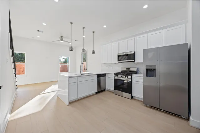 a kitchen with a refrigerator stove and microwave
