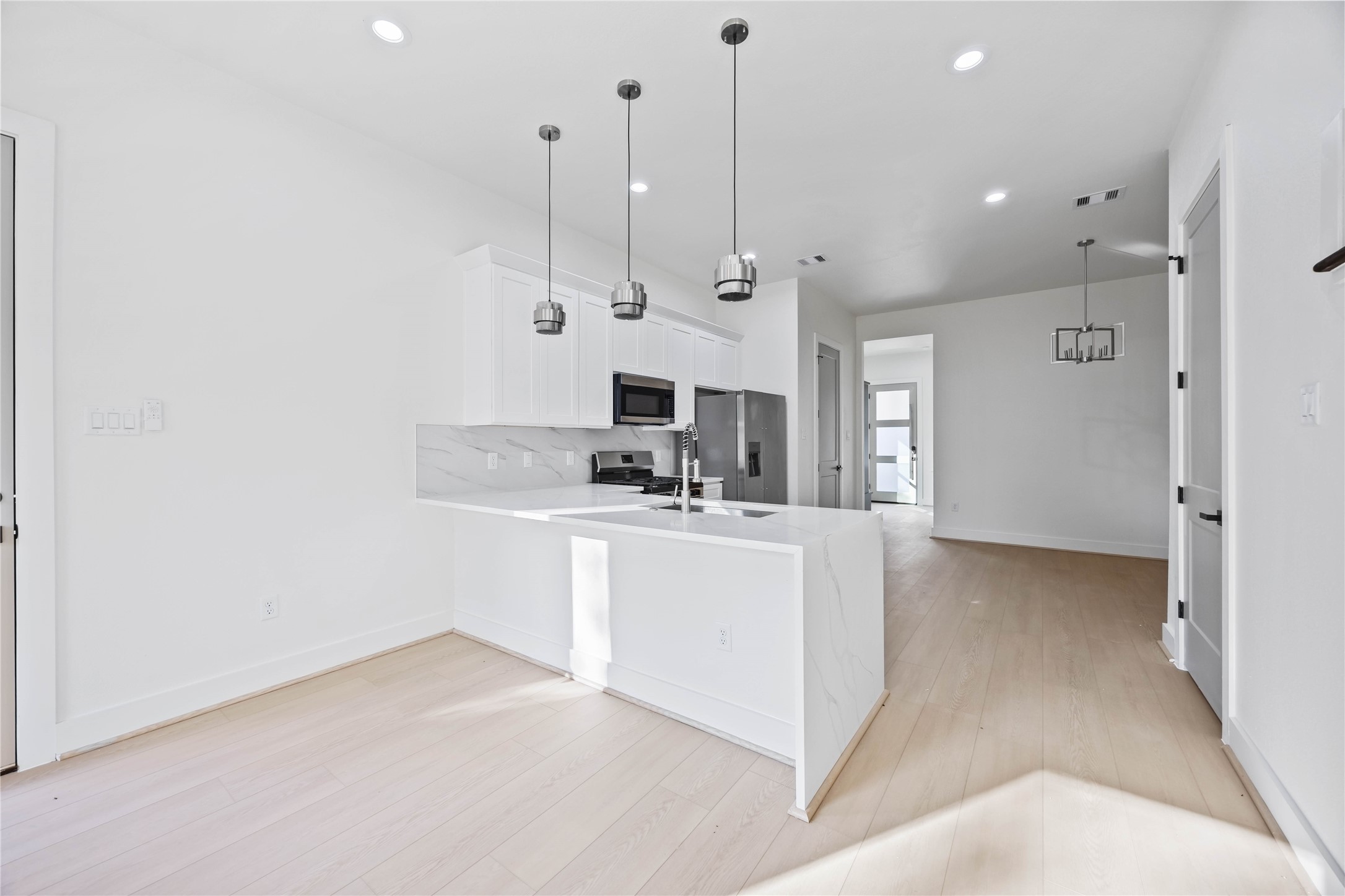 5222 Gold Street Houston, TX 77026 - Photo 10 of 28 a view of kitchen with stainless steel appliances granite countertop cabinets a sink and a wooden floor