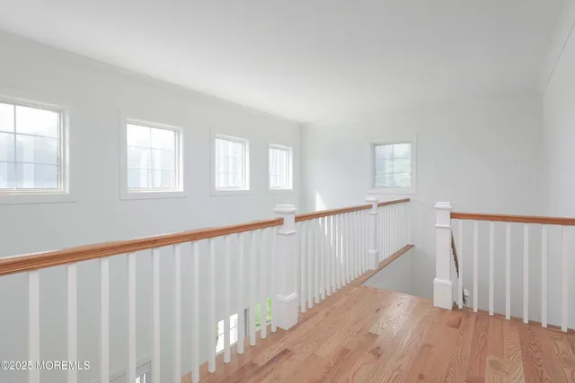 a view of a hallway with wooden floor and entryway