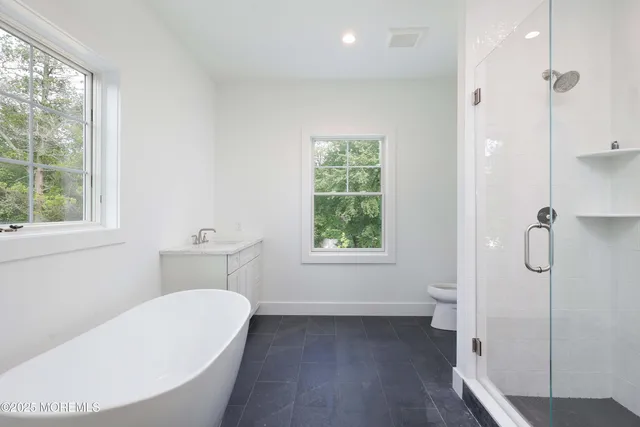 a bathroom with a toilet sink and shower
