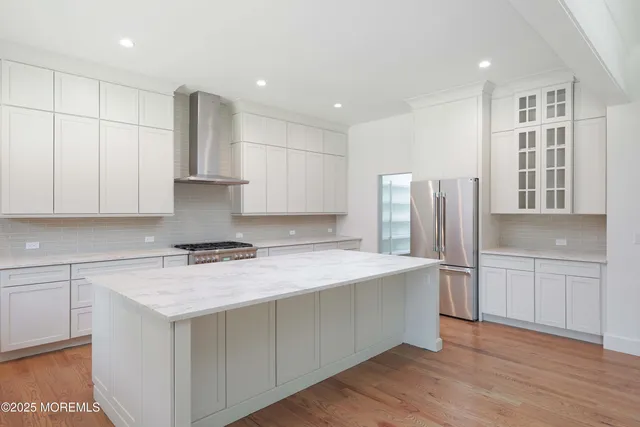 a kitchen with a refrigerator sink and cabinets